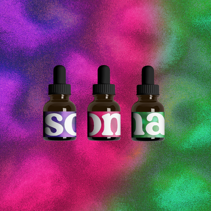 Three dropper bottles with colorful labels on a multicolored abstract background